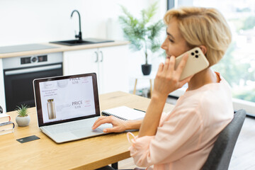 Caucasian woman browsing cosmetics website on laptop, ordering products online. Seated at desk,...