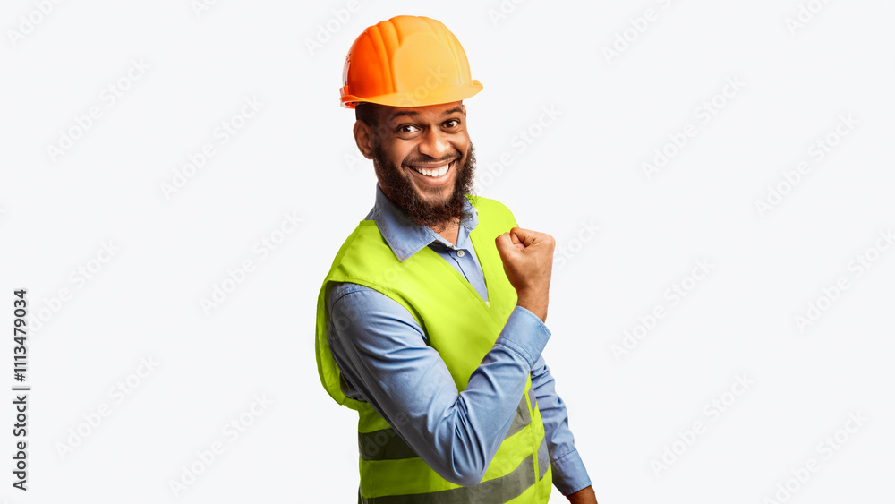 Poster joyful black construction worker man gesturing yes smiling to camera standing on white studio backgr