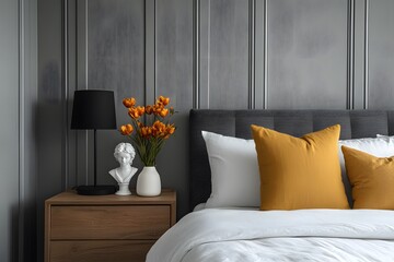 Cozy Bedroom Interior with Orange Accent Pillows, Fresh Tulips, and Modern Decor Elements on a Wooden Nightstand.