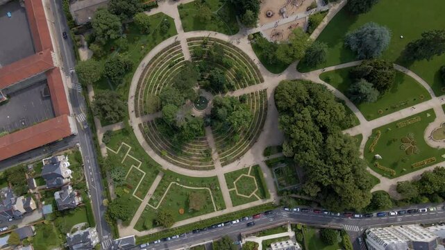 Sideway drone movement from the Parc du Thabor botanical and spiral garden, Rennes, France.