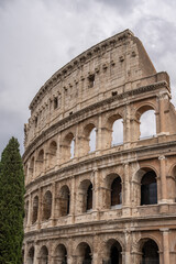 Naklejka premium Arches archictecture of Colosseum (Colosseo) exterior with clouds and sky. Rome, Italy.