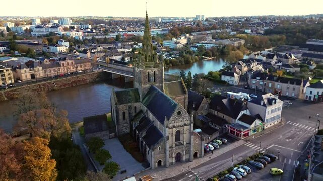 Backward drone movement from the Notre-Dame Basilica of Avesni&egrave;res in sunset, Laval, Mayenne, France.