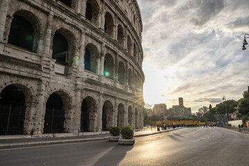 Fototapeta premium Arches archictecture of Colosseum (Colosseo) exterior with clouds and sky. Rome, Italy.