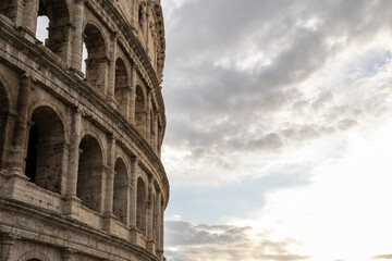 Arches archictecture of Colosseum (Colosseo) exterior with clouds and sky. Rome, Italy.