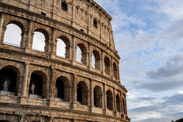 Arches archictecture of Colosseum (Colosseo) exterior with clouds and sky. Rome, Italy.