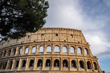 Obraz premium Arches archictecture of Colosseum (Colosseo) exterior with clouds and sky. Rome, Italy.