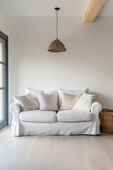 Cozy white sofa with decorative pillows in a bright minimalist living room