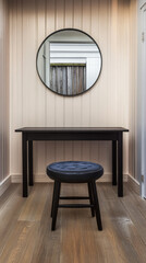 Fototapeta premium Minimalist design in a well-lit entryway featuring a mirror and a stool
