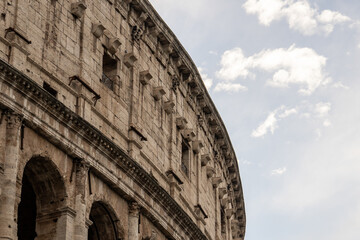 Obraz premium Arches archictecture of Colosseum (Colosseo) exterior with clouds and sky. Rome, Italy.