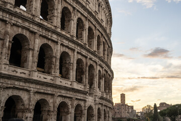Fototapeta premium Arches archictecture of Colosseum (Colosseo) exterior with clouds and sky. Rome, Italy.