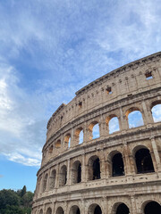 Fototapeta premium Arches archictecture of Colosseum (Colosseo) exterior with clouds and sky. Rome, Italy.