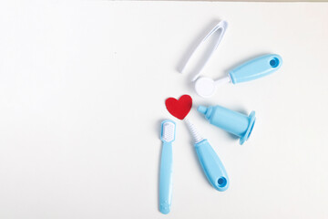 dentist tools for children isolated on white with red heart shapes. celebrate valentine day. playset for kids, imaginative learning montessori check or oral care tool.