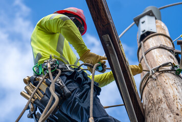 Lineman Performing Maintenance on a Utility Pole