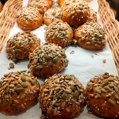 Freshly baked seed-covered bread rolls.