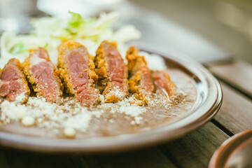 beef curry served on a plate.