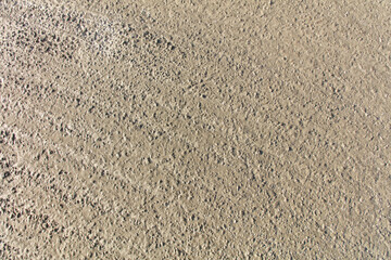 A sandy beach with a lot of rocks and pebbles