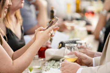 Woman on her phone at a dinner gathering