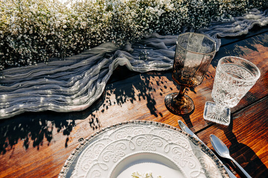 Sunny rustic outdoor table  place setting with baby's breath