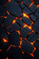 Fototapeta premium A black and orange photo of a rock with fire on it