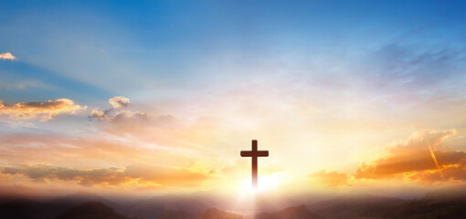 Cross of Jesus Christ on the sunset background.