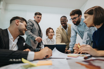 Diverse business employees are collaborating in a modern office, discussing ideas and strategies....
