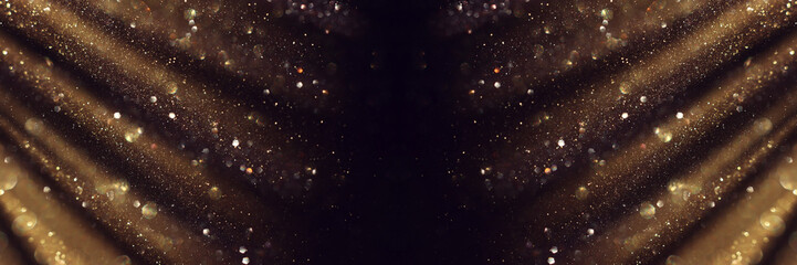 blackground of abstract glitter lights. gold and black. de focused. banner
