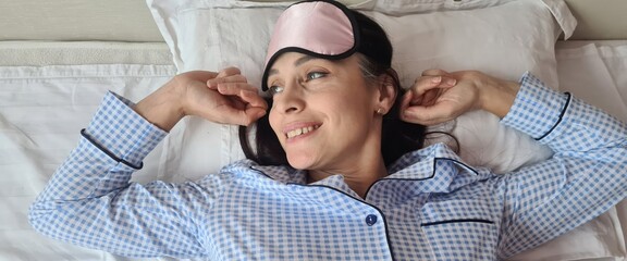 Fototapeta premium Attractive young woman wakes up in morning in bed