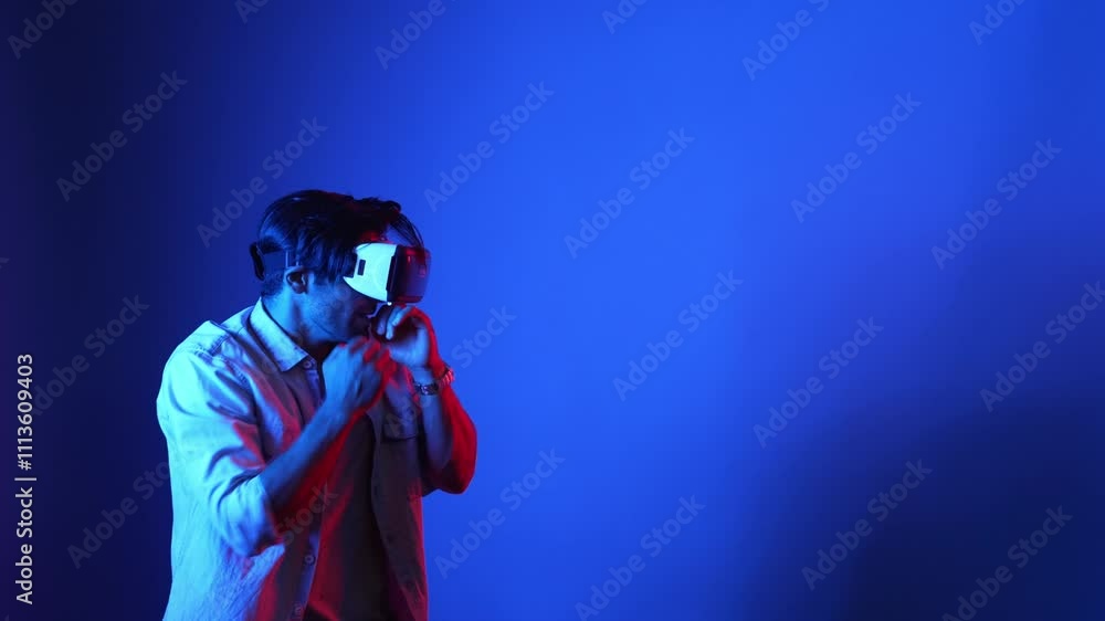 Poster skilled gamer making a punching posture by using virtual reality technology. side view of smart male