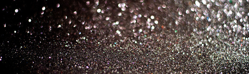 glitter vintage lights background. gold and black. de focused