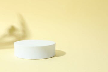 Props for product photography. White podium on a colored background