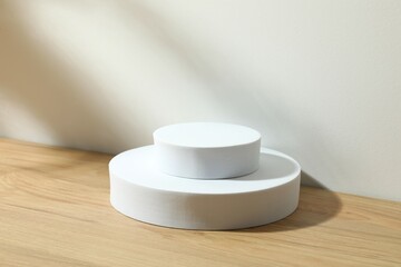 Props for product photography. Different podiums on a wooden table