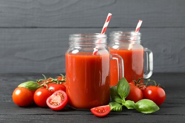 Tomato juice in a mason jars and fresh tomatoes on the table