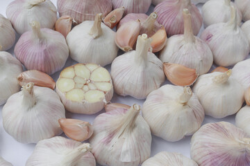 Garlic cloves, Chinese garlic. On white background dry food ingredients. For presentation, food, education, and garlic advertising.
