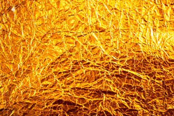 Seamless gold leaf background texture. Shiny golden yellow crumpled metallic foil repeat pattern. Modern abstract luxury gilded age wallpaper. Christmas glitter decoration backdrop. 3D rendering