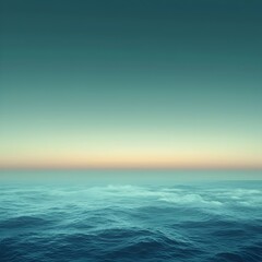 Obraz premium A serene and tranquil view of the ocean at dusk, showcasing gentle waves under a soft gradient sky, with shades of teal and amber meeting at the horizon.