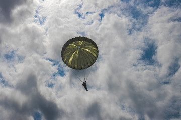 German paratroopers participate in a NATO exercise, descending with precision from aircraft using...