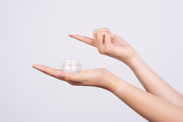 A woman's hand holding a cream jar. A woman who takes good care of her hands