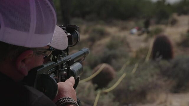 Hunter with air soft gun shooting targets
