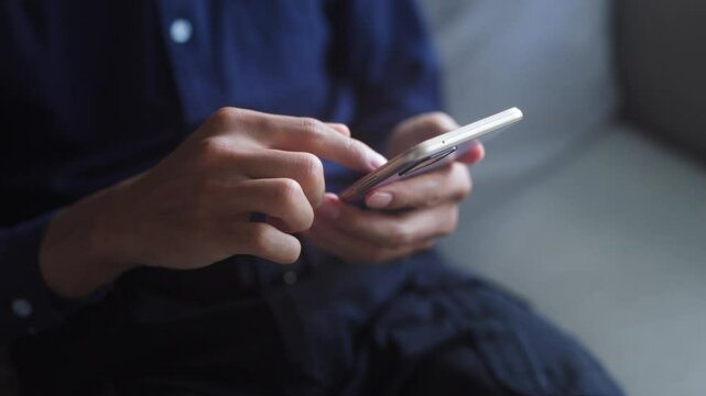 Man hold smartphone mobile addict spending time checking social media on sofa in  living room