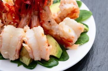Salad with tiger shrimps , avocado and mango . Top view