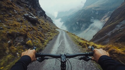 Riding a mountain bike along a narrow gravel path, surrounded by steep cliffs and misty valleys. The atmosphere is cool and cloudy, adding to the sense of adventure in this breathtaking landscape.