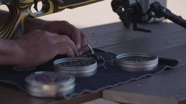 Loading pellet magazine at the gun range