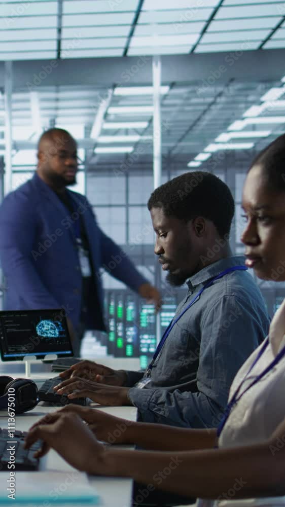 Poster vertical video data center engineers maintaining company network infrastructure by installing, confi
