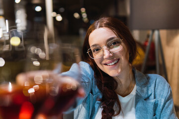 Romantic moments. Woman toasting with a glass of red wine