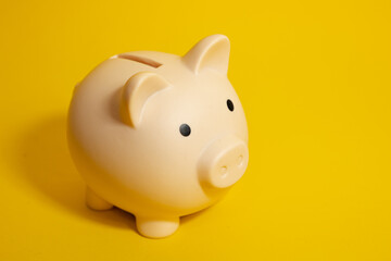 Piggy bank on a yellow isolated background, savings and finance concept