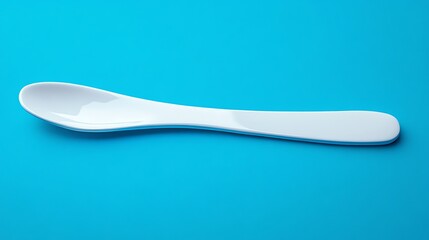 A white spoon on a blue background.