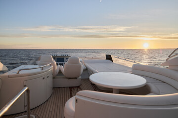 A Spectacular Luxury Yacht Gliding Across Calm Waters as the Sunset Paints the Sky