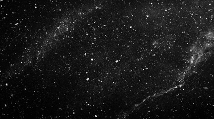 A Black Background Scattered with White Specks of Dust