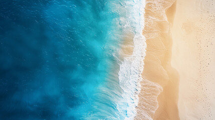 Aerial view of sandy beach with turquoise waves and footprints