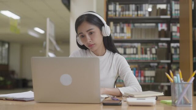 Young asian college student online learning course on laptop - Powered by Adobe